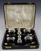 George V cased hallmarked silver cruet set comprising two each of open salt, mustard and pepper, the