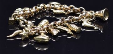 A 9ct gold charm bracelet with seventeen 9ct gold charms including a penguin, cat, heart, dolphin,
