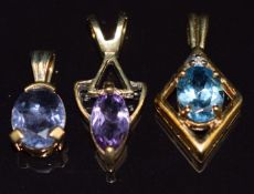 Three 9ct gold pendants set with amethyst, topaz and quartz, 4g