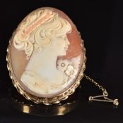 A 9ct gold brooch set with a cameo depicting a young woman