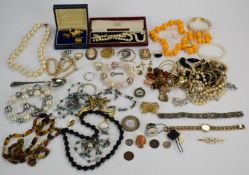 A collection of costume jewellery including beads, silver cross pendant, D & G ring, compass