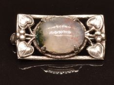 Arts & Crafts silver brooch set with a moss agate cabochon