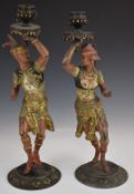 A pair of 19/20thC painted metal figural candlesticks of Indian dancers, H37cm