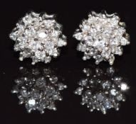 A pair of 9ct white gold earrings set with diamonds in a cluster, 2.2g