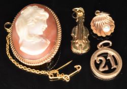 A 9ct gold brooch / pendant set with a cameo and three 9ct gold charms, 2g