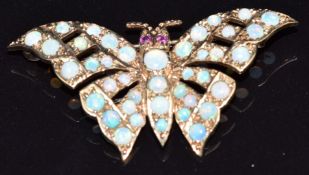 A 9ct gold brooch in the form of a butterfly set with opals and ruby eyes, 4.9g