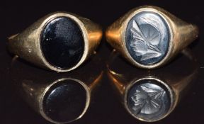 A 9ct gold signet set with with a hematite intaglio and a 9ct gold signet ring set with onyx, size