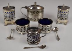 Hallmarked silver blue glass lined salts, mustards and peppers, comprising a pair of peppers and