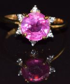 A 9ct gold ring set with a ruby surrounded by white sapphires, size M, 3.3g