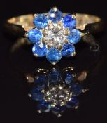 A 9ct gold ring set with a diamond surrounded by sapphires, size J, 2.1g