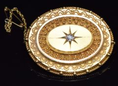 Victorian Etruscan Revival yellow metal brooch set with an old cut diamond in a star setting