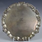 George V hallmarked silver card tray with shaped edge, raised on three scrolling feet, Birmingham