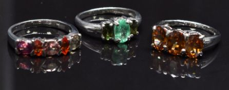 Three 9ct gold rings, one set with an emerald, one a citrine and the other zircon, size N, 9.5g
