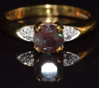 A 9k gold ring set with colour change andesine and diamonds, size M, 2.7g