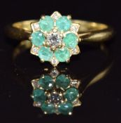 An 18ct gold ring set with a diamonds and emeralds, size M, 3.5g