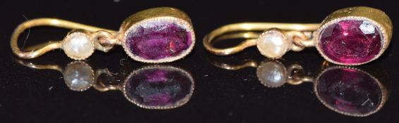 A pair of Edwardian 9ct gold earrings set with a garnet and seed pearl to each, in original box