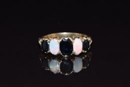 A 9ct gold ring set with oval cut sapphires and opal cabochons, size N, 3.6g