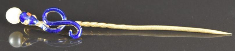 Victorian yellow metal stick pin in the form of a snake/ serpent set with blue enamel and holding