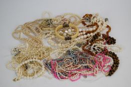 A collection of pearl necklaces and an ivory and silver bangle