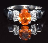 A 9k gold ring set with an oval cut garnet and diamond, size M, 3.3g