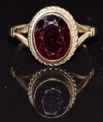 A 9ct gold ring set with a garnet, size L, 2.8g