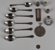 A collection of silver including four matching spoons, two further spoons, money clip, thimbles