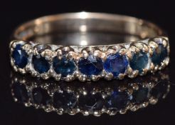 A 9ct gold ring half eternity ring set with sapphires, size M, 1.8g
