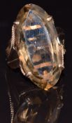 A 9ct gold ring set with a large oval smoky quartz, size N, 10.1g