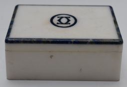 A marble and lapis lazuli/ sodalite jewellery or trinket box with inlaid Cartier symbol to the
