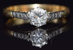 An 18ct gold ring set with a round cut diamond of approximately 0.5ct in a platinum setting, size N,