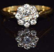 An 18ct gold diamond daisy cluster ring, the centre diamond aprroximately 0.3cts, size N, 2.2g