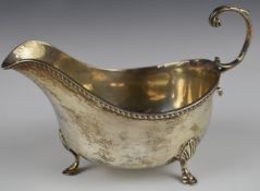 George V hallmarked silver sauce boat with gadrooned edge, raised on three feet, Birmingham 1911,