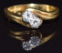An 18ct gold ring set with two diamonds of approximately 0.15ct in a twist setting, size N, 4.8g