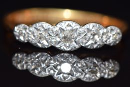 An 18ct gold ring set with five diamonds in a platinum setting, size L, 2.1g