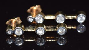 A pair of 9ct gold earrings each set with four diamonds, total diamond weight approximately 0.
