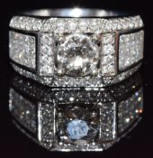 An 18ct white gold ring set with a round cut diamond of approximately 1ct, further round cut