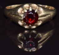 A 9ct gold ring set with a garnet, size S, 2.5g
