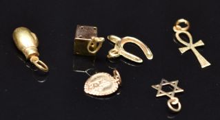 Six 9ct gold charms including boxing glove, St Christopher, dice, etc, 2.4g