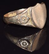 A 9ct gold shield shaped signet ring with embossed flower decoration to the shoulders, Birmingham