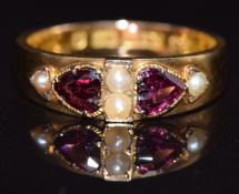A 15ct gold ring set with heart cut garnets and seed pearls, Birmingham 1867, size K, 1.8g