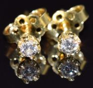 A pair of 18ct gold earrings set with a diamond of approximately 0.1ct to each, 1.3g