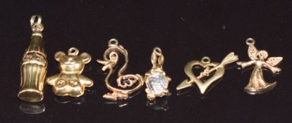 Six 9ct gold charms comprising Coco Cola, heart, teddy bear, duck, rabbit and angel, 5.3g