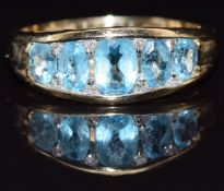 A 9ct gold ring set with blue topaz and diamonds, size N, 2.5g