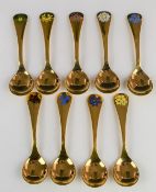Nine Georg Jensen silver gilt spoons, each with floral enamel decoration, a run from 1982 to 1991
