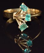 A yellow metal ring set with three emerald cut emeralds, size M, 2.6g