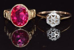 A yellow metal ring set with diamonds in a platinum star setting and a 10k gold ring set with a