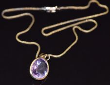 A 9ct gold necklace and 9ct gold pendant set with an oval cut amethyst measuring approximately 14.
