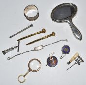 A collection of items including silver mirror, silver brooches, cigar cutter, seal, silver pencil,