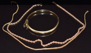 Two 9ct gold necklaces (8.9g) and an 18k gold bangle with cut out decoration, 10.7g
