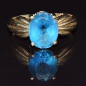 A 9ct gold ring set with an oval cut topaz, size M, 3g